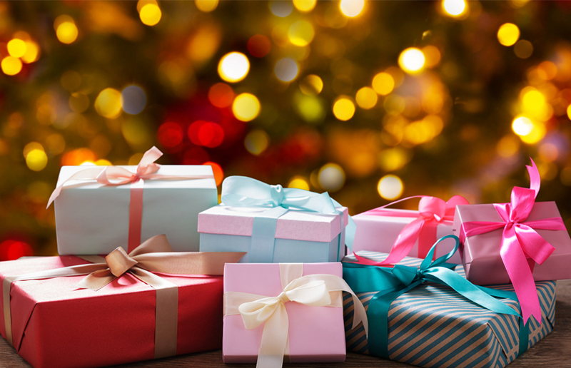 Christmas gift boxes on wooden table on a festive background